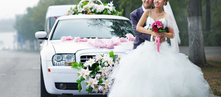 Happy Couple Posing in Front of White Limousine